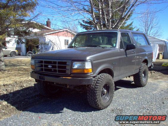 Gray 1993 Ford Bronco with off-road tires parked outdoors