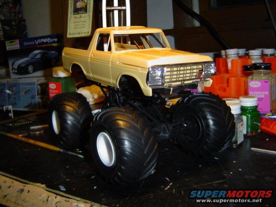 Yellow model monster truck with large tires, 3q-front view
