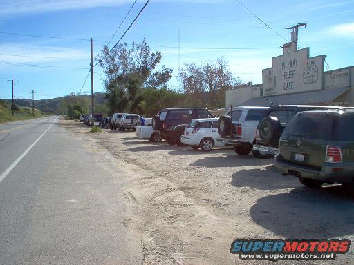Several SUVs and trucks parked outside Halfway House Cafe