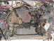 1985 Ford Crown Victoria LTD - The engine bay of a vehicle is shown with exposed wiring, transmission components, and a steering column, indicating a disassembled state.