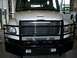 1978 Ford F-250 - White truck with a heavy-duty black grille guard and bumper is parked indoors.