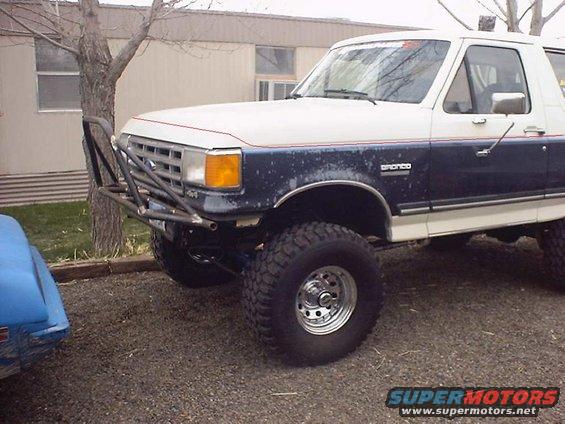 1988 Ford Bronco with aftermarket front bumper and lifted suspension