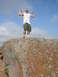 1986 Ford Bronco - A man poses by flexing his biceps while standing on a large rock formation.