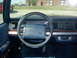 1990 Ford Crown Victoria - The interior of a car is shown, focusing on the dashboard and steering wheel. A watermark for SUPERMOTORS is present.