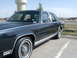 1990 Ford Crown Victoria - A dark blue 1990 Ford Crown Victoria sedan is parked outdoors, viewed from the front three-quarter angle.
