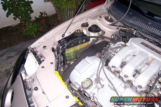 1998 Mercury Sable engine bay, tan exterior, close-up view of engine components and coolant reservoir
