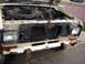 1986 Ford Bronco II - Front view of a 1986 Ford Bronco II with the hood open, revealing the engine and grille.