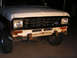 1986 Ford Bronco II - The front grille and bumper of a 1986 Ford Bronco II show signs of rust and wear.