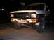 1986 Ford Bronco II - Front view of a 1986 Ford Bronco II with a two-tone paint scheme and visible rust on the bumper.