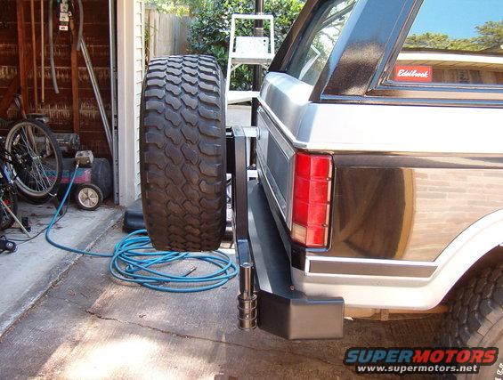 Rear view of a Ford Bronco with a spare tire mounted externally. Edelbrock sticker visible on rear window