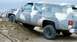 1979 Chevrolet Suburban - 1973 Chevrolet Suburban driving off-road on a dirt mound.