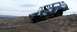 1979 Chevrolet Suburban - A camouflaged Chevrolet Suburban navigates an off-road incline under a cloudy sky.
