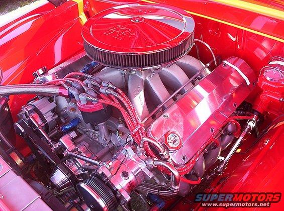 Close-up of a shiny red V8 engine with chrome parts and red spark plug wires