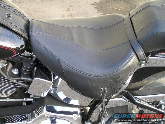 Black motorcycle seat with leather trim and lacing