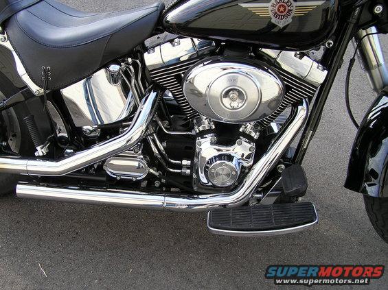 Close-up of a 2000 Harley-Davidson Fat Boy's engine, exhaust pipes, and seat