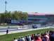 1978 Ford F-250 - A drag racing event is underway with cars on the track and spectators watching from the stands.