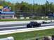 1978 Ford F-250 - Two vehicles compete on a drag strip, with grandstands and advertising visible.