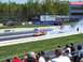 1978 Ford F-250 - A drag car performs a burnout on a race track, creating a large cloud of smoke.