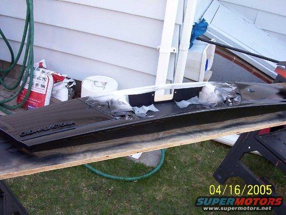 Black car part with CROWN VICTORIA text