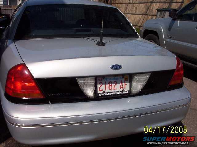 Rear of a silver Ford Crown Victoria with a black accent panel and license plate 2182 AF