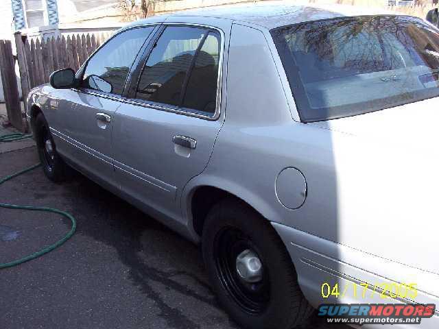 Silver 1999 Ford Crown Victoria side view