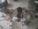 1983 Ford F-250 - Disassembled rear axle assembly with gears and tools scattered around on a concrete floor.