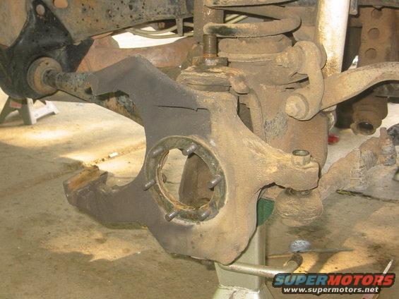 close-up of rusty vehicle suspension components on jack stands