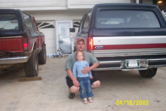 Rear view of a dark blue and red Ford Bronco with a license plate reading "ORRIERS"