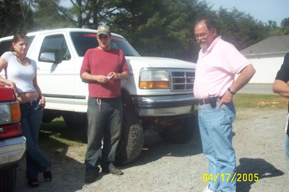 White Ford F-Series truck with chrome grille and headlights, seen from a 3/4 front angle