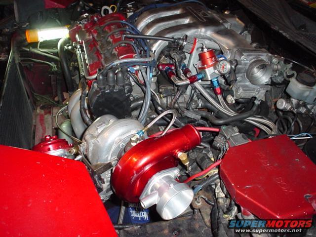 Engine bay with turbocharger, fuel pressure regulator, and fuse box