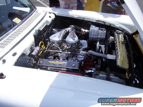 engine bay with dual carburetors, chrome air cleaners, and a 'Thunderbird' valve cover