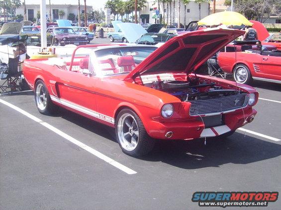 Red 1965 Ford Mustang convertible, hood open, GT-350 stripe