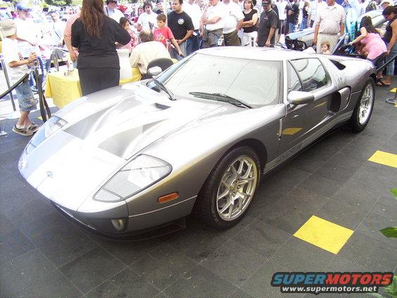 Silver Ford GT with racing stripes on hood and roof