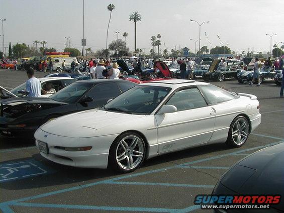 White 1993 Ford Probe GT parked in a lot, 3/4 front view, with custom wheels