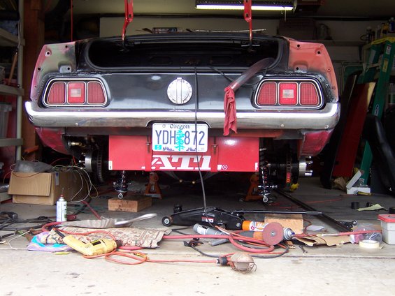 1971 Ford Mustang rear end on jack stands, trunk open, Oregon license plate YDH 872 visible