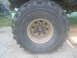 1983 Ford F-250 - A close-up view of a large off-road tire, identified as a 'SUPER SWAMPER', mounted on a white rim.