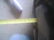 1983 Ford F-250 - A yellow tape measure is used to measure the width of a dark-colored tire.