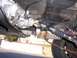 1989 Jeep YJ - The underside of a vehicle reveals the transmission and driveshaft, with a red sticker visible on the transmission housing.