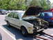 1998 Volkswagen Jetta - This beige Volkswagen Jetta is undergoing engine work, with its hood and front end disassembled.