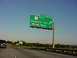1998 Volkswagen Jetta - A green highway sign indicates an upcoming exit for Cosgrove Ave and Naval Base.