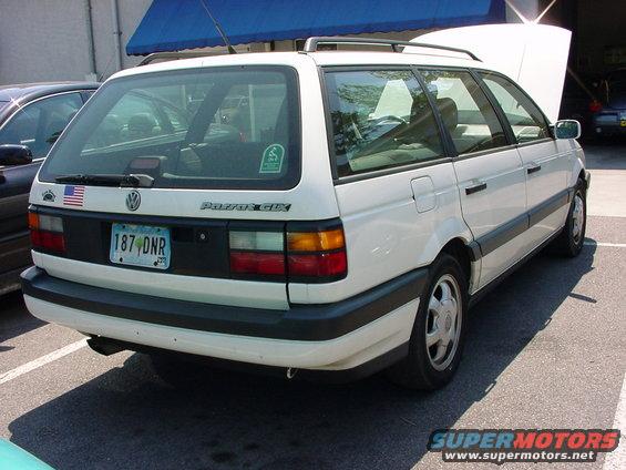 White Volkswagen Passat GLX wagon, rear view, license plate 187 DNR, American flag sticker