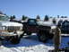 1979 Ford F-150 - Two pickup trucks are parked in a snowy field under a clear blue sky.