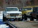 1979 Ford F-150 - Three lifted pickup trucks are parked outdoors in a snowy area, with one in the foreground.