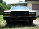 1985 Ford Crown Victoria LTD - This 1985 Ford Crown Victoria LTD is shown from the front, parked in a grassy area near a building.