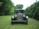 1929 Ford Model A - A classic 1929 Ford Model A sits on a grassy lawn surrounded by trees.