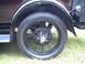 1929 Ford Model A - Close-up view of the black wire wheel and fender of a 1929 Ford Model A, highlighting its vintage design.