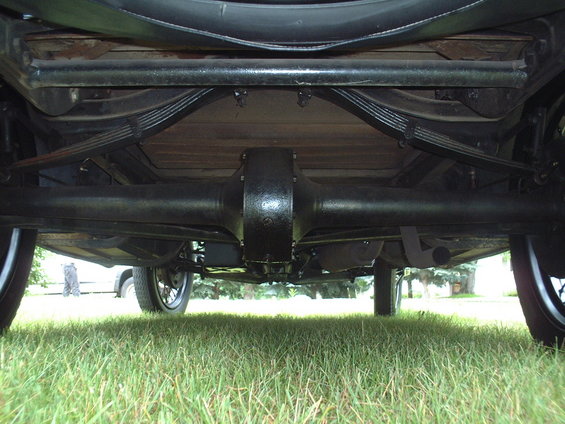Underside of a 1929 Ford Model A showing the rear axle, leaf springs, and wooden floorboards