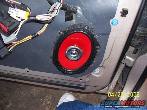Car door panel with a red speaker and wiring harness. Date stamp reads 04/20/2005