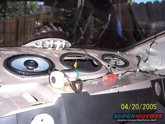 Car interior dashboard with speaker holes and wiring visible, date stamp 04/20/2005