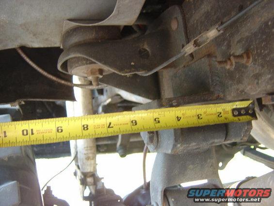 Measuring tape on suspension component, showing 6 inches